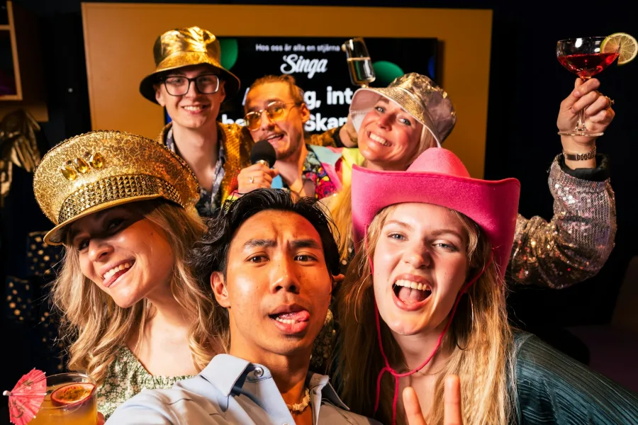 Guests enjoying a carnival-themed photo booth