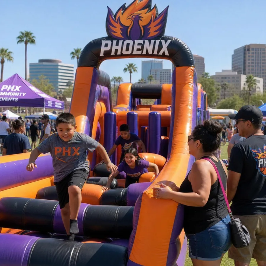 families enjoying a themed inflatable obstacle course at a Phoenix community event