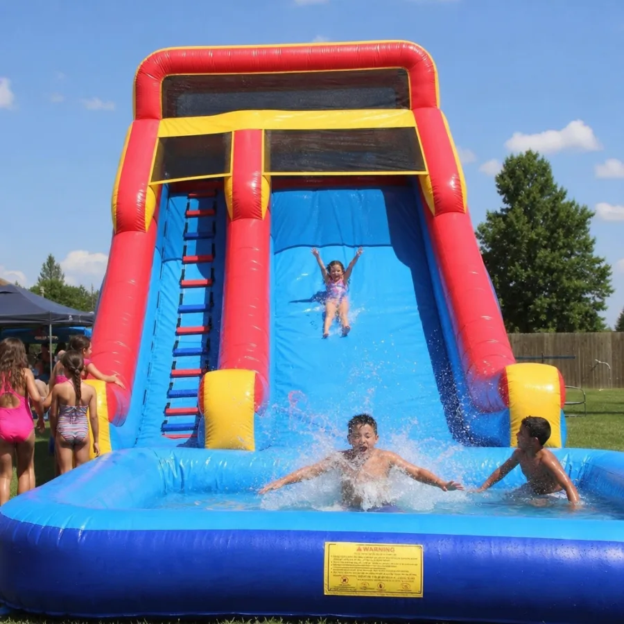 A giant inflatable water slide with kids splashing into the pool at the bottom