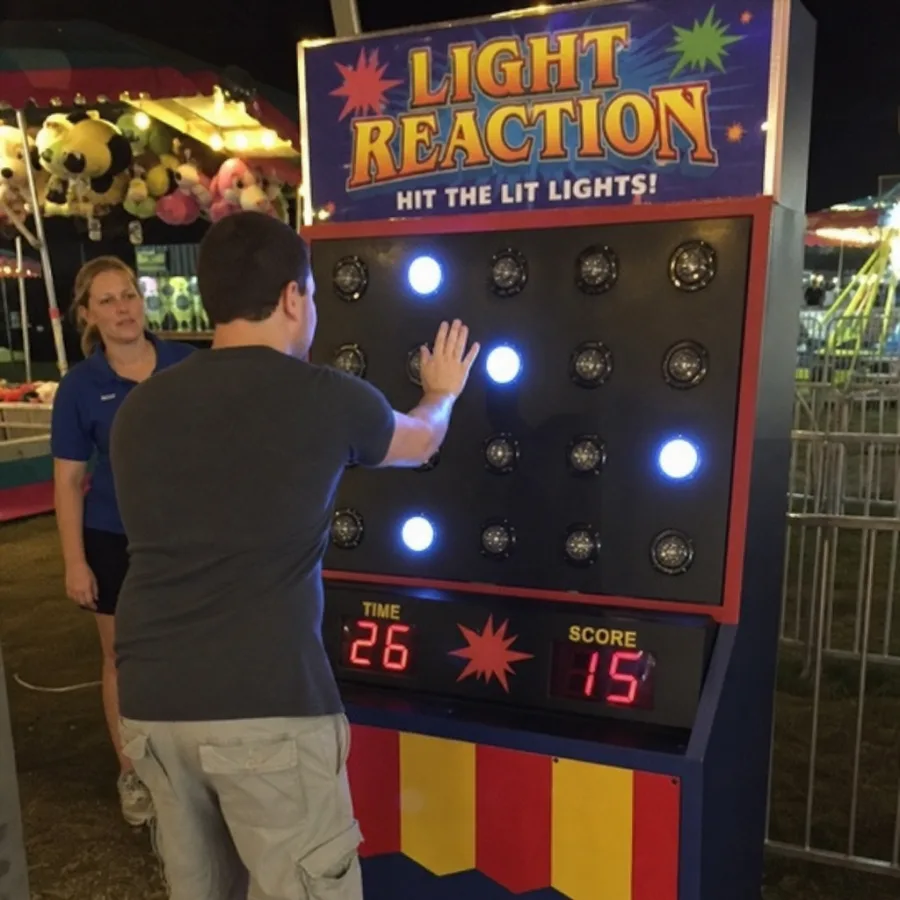 guest playing a light reaction carnival game
