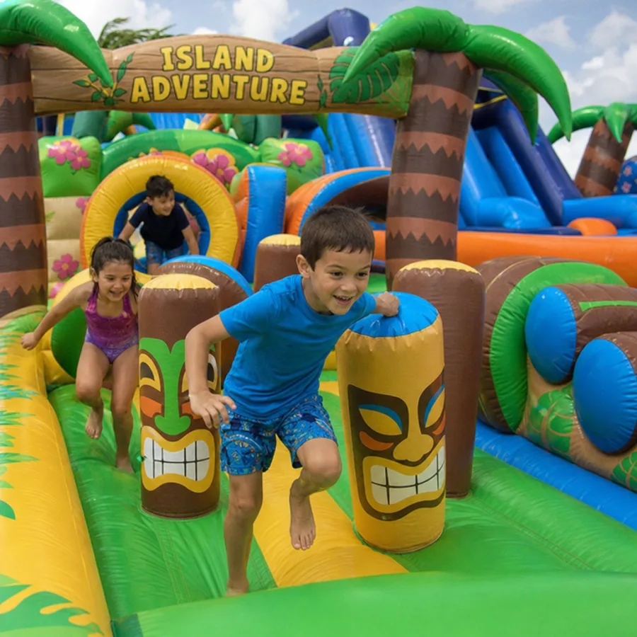 Children racing through a colorful island themed inflatable obstacle course