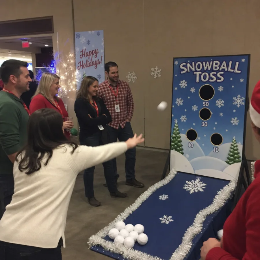 Group of guests watching a winter-themed skill game rental at a holiday event