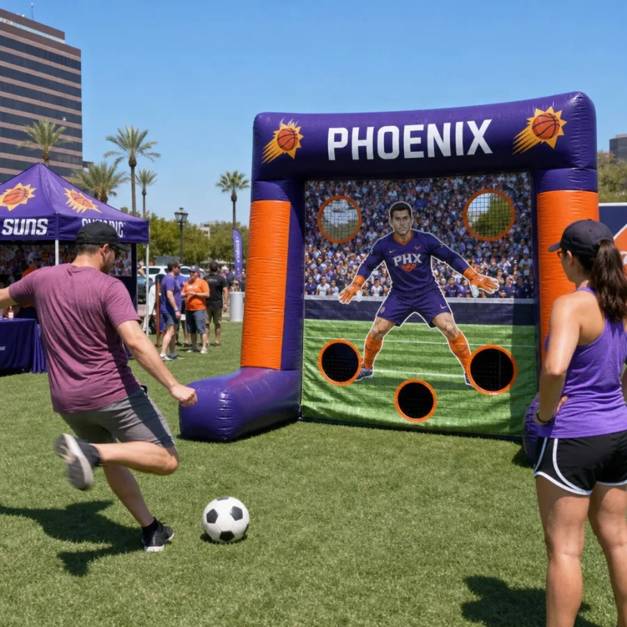 Guests playing an inflatable soccer kick game at a Phoenix outdoor event