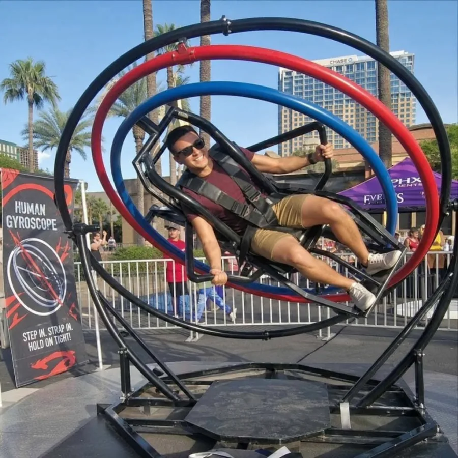 Guest enjoying a human gyroscope ride at an outdoor Phoenix event