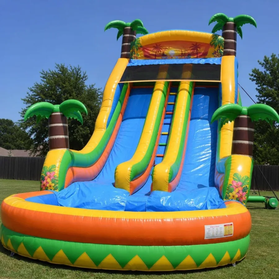 A giant double-lane inflatable water slide featuring bright tropical colors and palm tree decorations