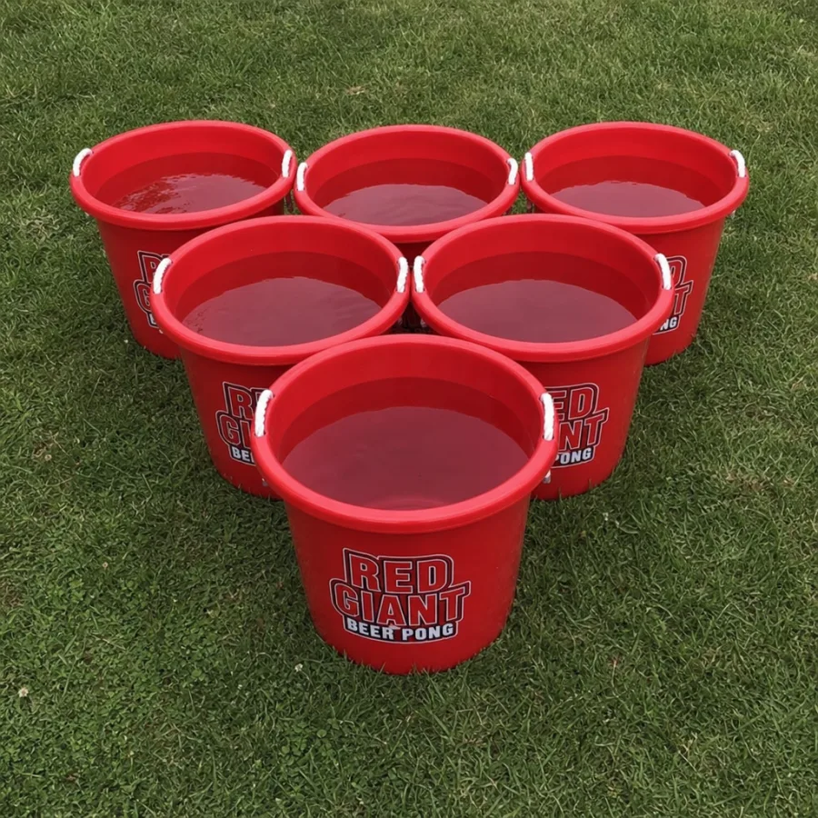 A perfect triangular setup of 6 red giant beer pong buckets on green grass with water inside for weight