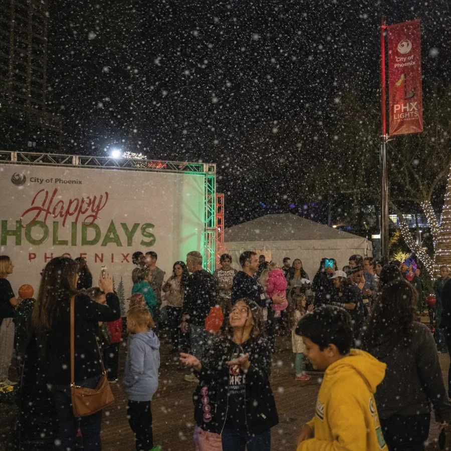 Artificial snow falling at an outdoor Phoenix holiday event