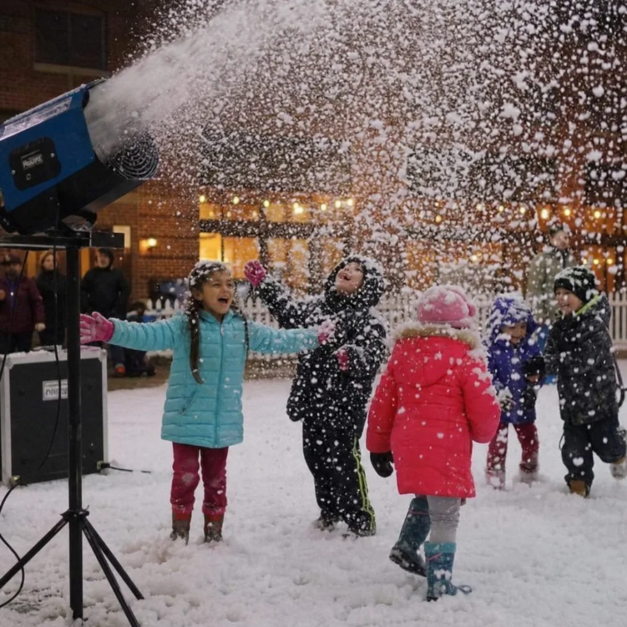 Children playing under artificial snow from a rental snow blower