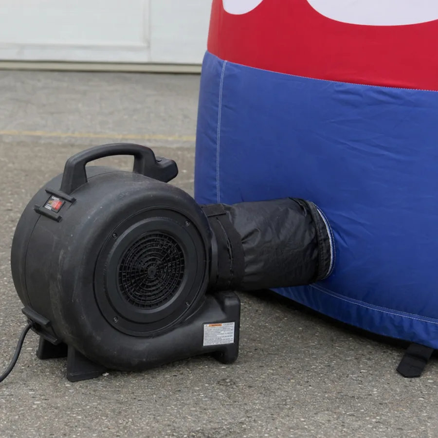 Close up of an outdoor electrical blower connected to a commercial inflatable advertisement